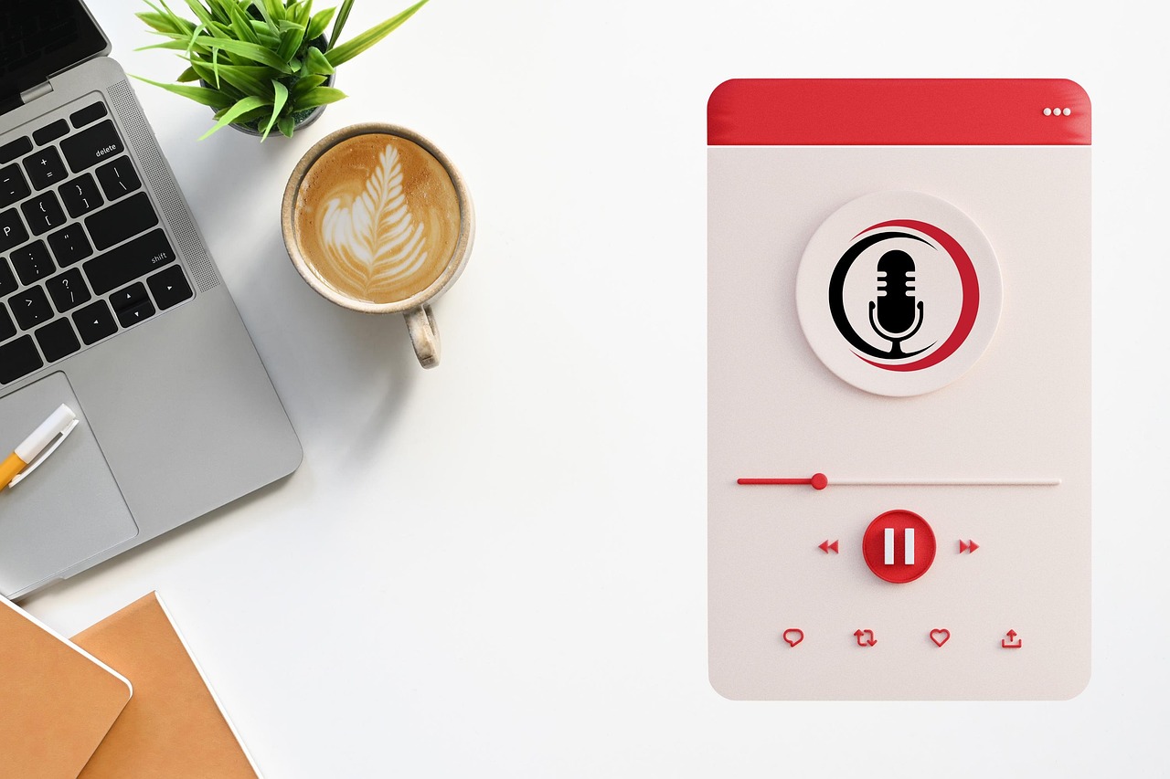 An image of a laptop, a cup of coffee, and a podcast player.